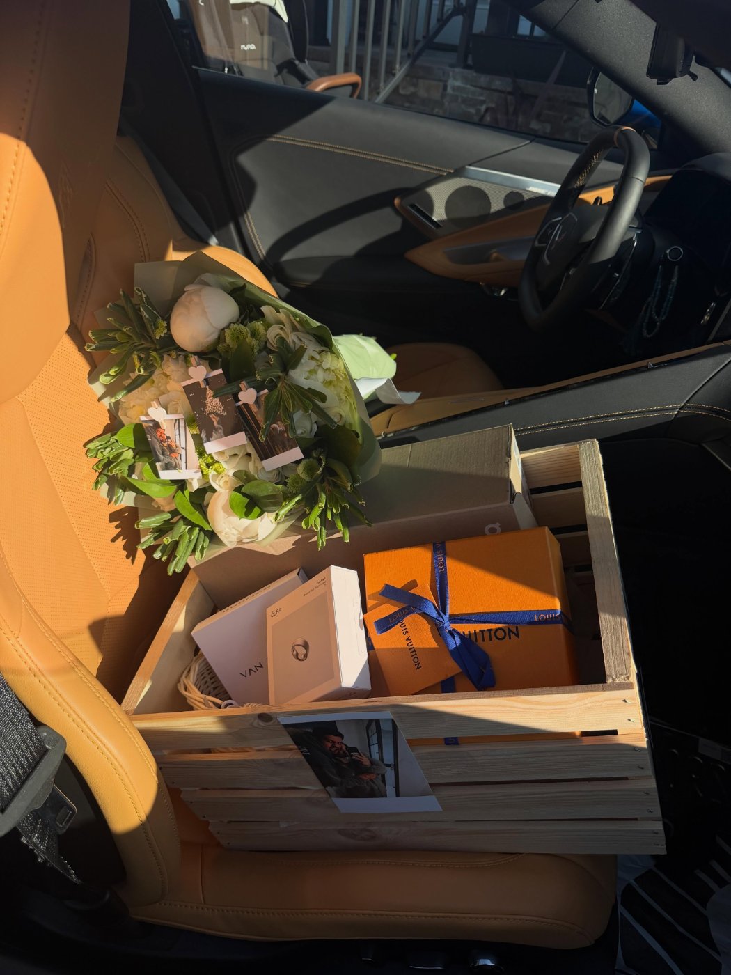A green-and-white bouquet paired with a designer gift in a keepsake crate